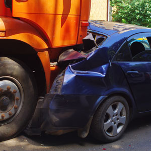 Blue car, damaged after hitting the truck