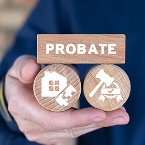 Hand holding wooden tokens; one says ‘PROBATE’, two others have house and gavel icons.